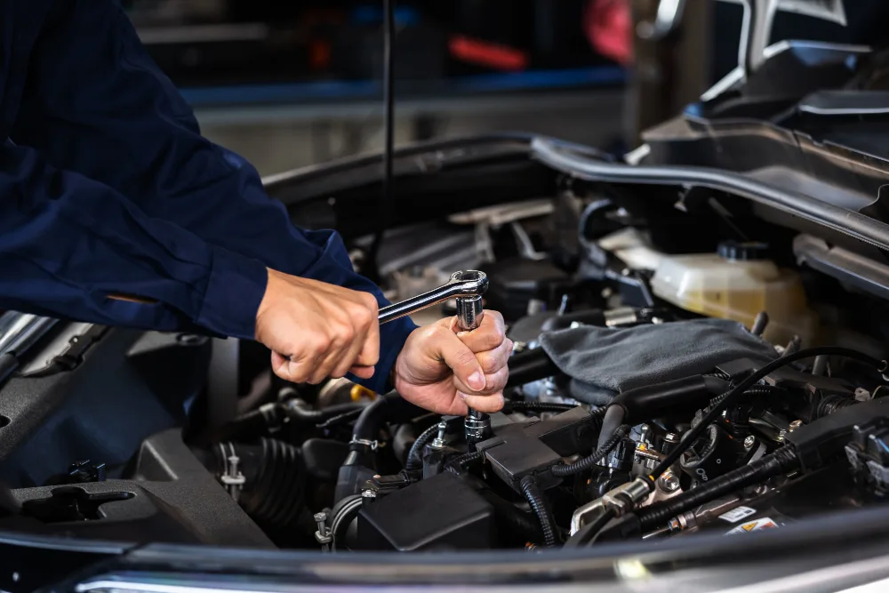 Mechanic repairing overheating car engine in Perth