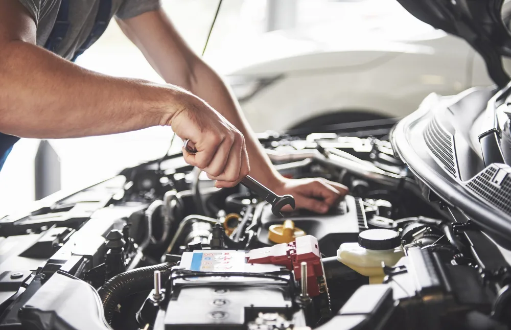 Mechanic performing engine oil change during car service Perth